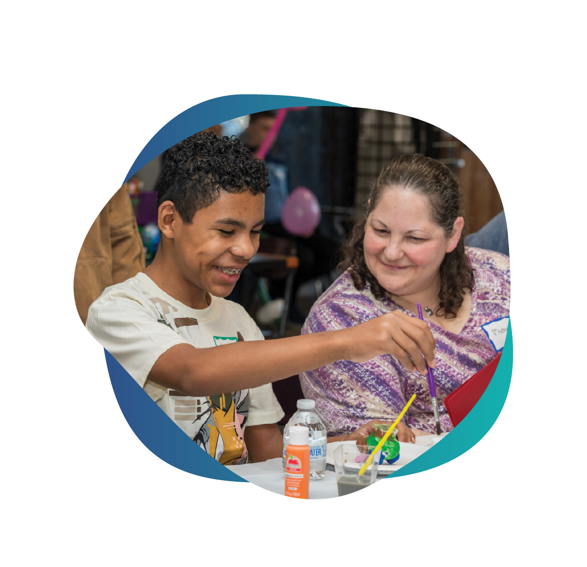 child and adult painting pottery